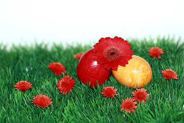 Image showing Red flowers and colored eggs