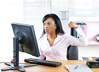 Image showing Angry black businesswoman at desk