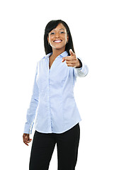 Image showing Smiling young woman pointing finger forward