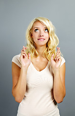 Image showing Hopeful woman crossing fingers