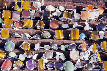 Image showing rings from amber stones sold outdoor market fair 