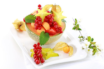 Image showing Fresh fruits served in melon bowl