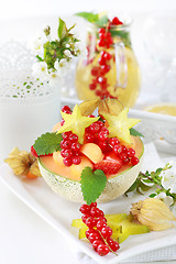 Image showing Fresh fruits served in melon bowl