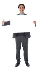 Image showing Business professional pointing towards an empty billboard