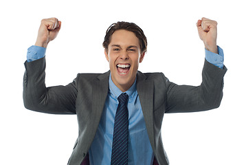 Image showing Excited businessman rasing his arms and cheering joyfully