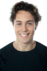 Image showing Closeup of young handsome guy enjoying music