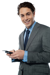 Image showing Handsome young man navigating on his smartphone