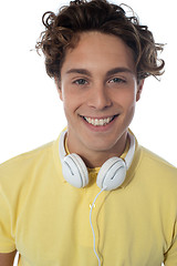 Image showing Guy with headsets around his neck smiling at you