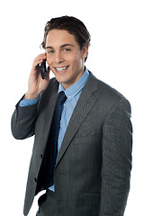 Image showing Portrait of a smiling businessman using a cellphone