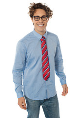 Image showing A young teenager in blue shirt, jeans and tie