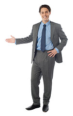 Image showing Successful businessman presenting over white background