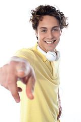 Image showing Guy with headphones pointing at you