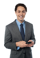 Image showing Handsome businessman using a smartphone