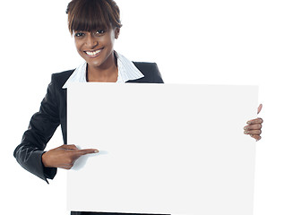 Image showing Corporate female executive pointing towards blank banner