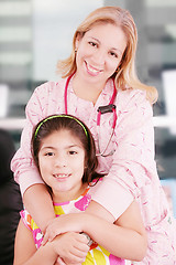 Image showing Little cheerful girl visiting the doctor 