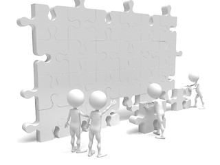 Image showing business teamwork - business men making a puzzle over a white ba