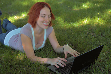 Image showing Woman using laptop in park