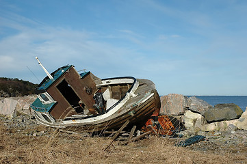 Image showing old wooden boats on rocky seaside