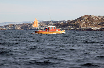 Image showing old wooden boats on rocky seaside