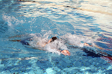 Image showing a man swimming backstroke