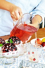 Image showing Woman pouring lemonade