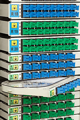 Image showing fiber optic rack with high density of blue and green SC connectors