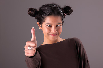 Image showing beautiful and happy young woman, with tumb up