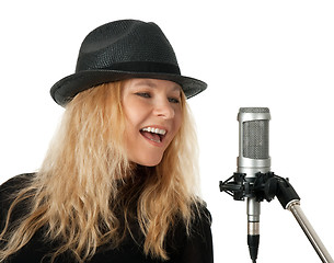 Image showing Singer in black hat singing with the microphone