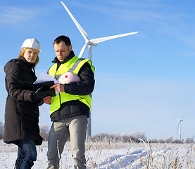 Image showing team of  engineers or architects with white safety hat and wind 