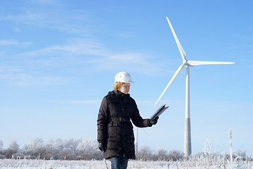 Image showing engineer or architect with white safety hat and wind turbines on