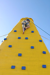 Image showing Child coming down from a climbing wall