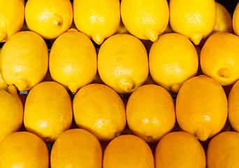 Image showing yellow background, texture of many lemons in market