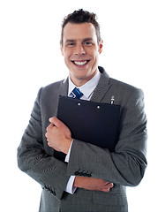 Image showing Happy businessman holding a clipboard