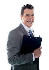 Image showing Businessman holding clipboard