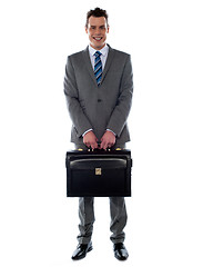 Image showing Comany's CEO holding his handbag