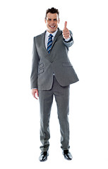 Image showing Confident businessman gesturing thumbs up