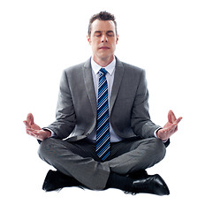 Image showing Businessman meditating in lotus position