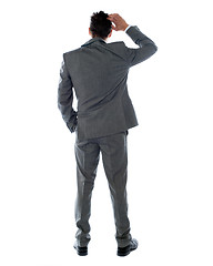 Image showing Back-pose of a corporate person thinking