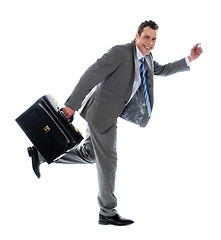 Image showing Full length portrait of a businessman running away