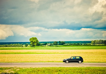 Image showing Field and car on a road