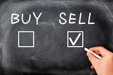 Image showing Buy or sell check boxes written on a blackboard