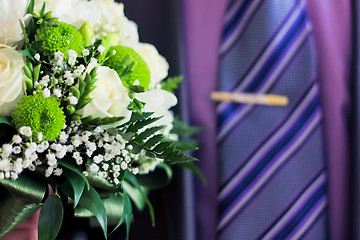 Image showing man's hand with white roses