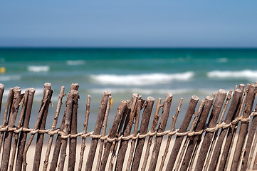 Image showing Beach: blue sea, sand and fence