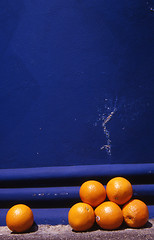 Image showing Oranges against blue wall