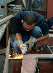 Image showing Man working with angle grinder