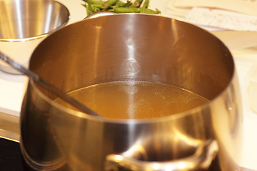 Image showing aluminum pot with vegetable broth in a kitchen