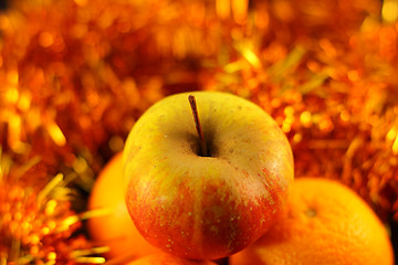 Image showing apple close-up on a background of twinkling garlands