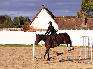 Image showing pretty young woman rider in a competition riding