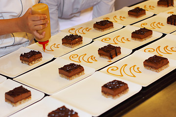 Image showing preparation of dessert plates for a chocolate cake louis XV