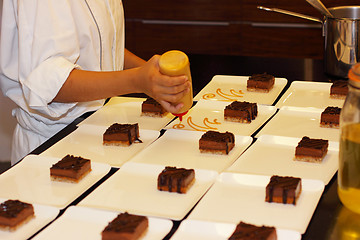 Image showing preparation of dessert plates for a chocolate cake louis XV